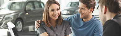 young couple purchasing a new vehicle